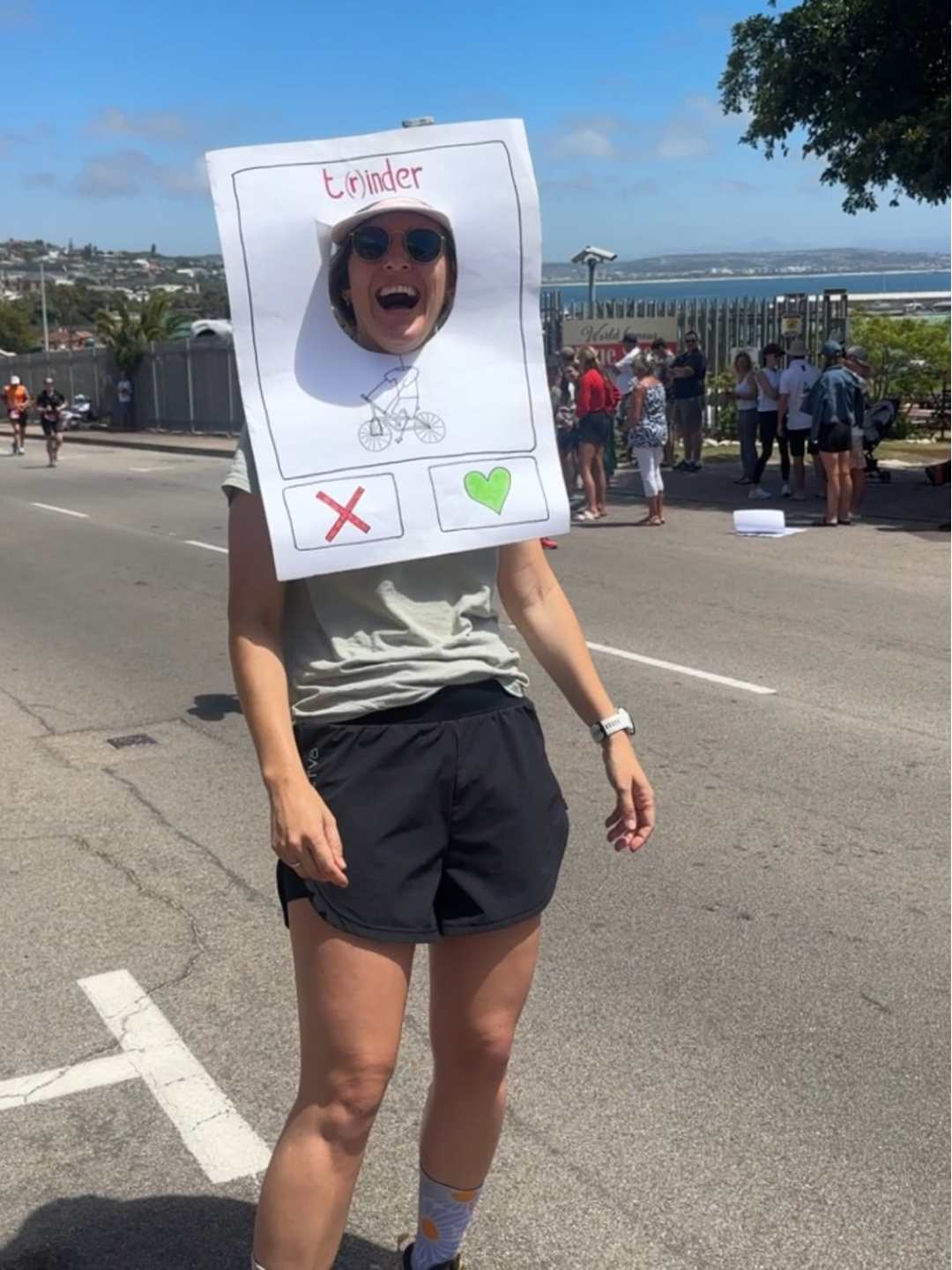 Motivational running sign that supporters can stick their head through and athletes can "swipe right" on them like a tinder profile.